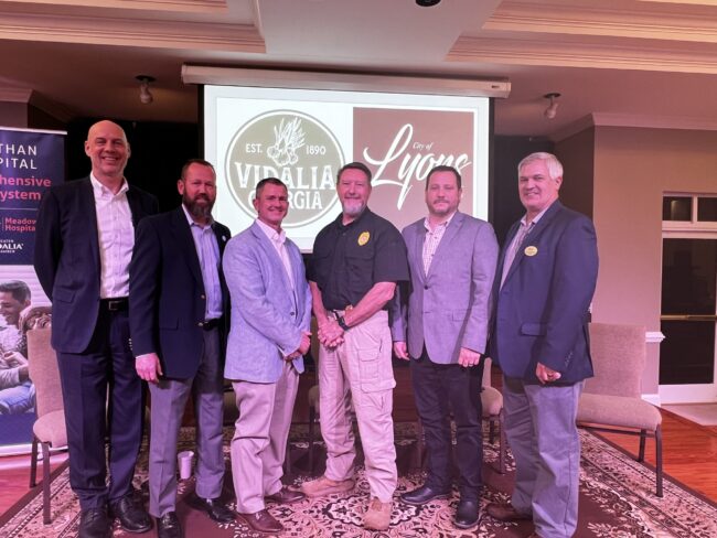 6 men in a line on the stage